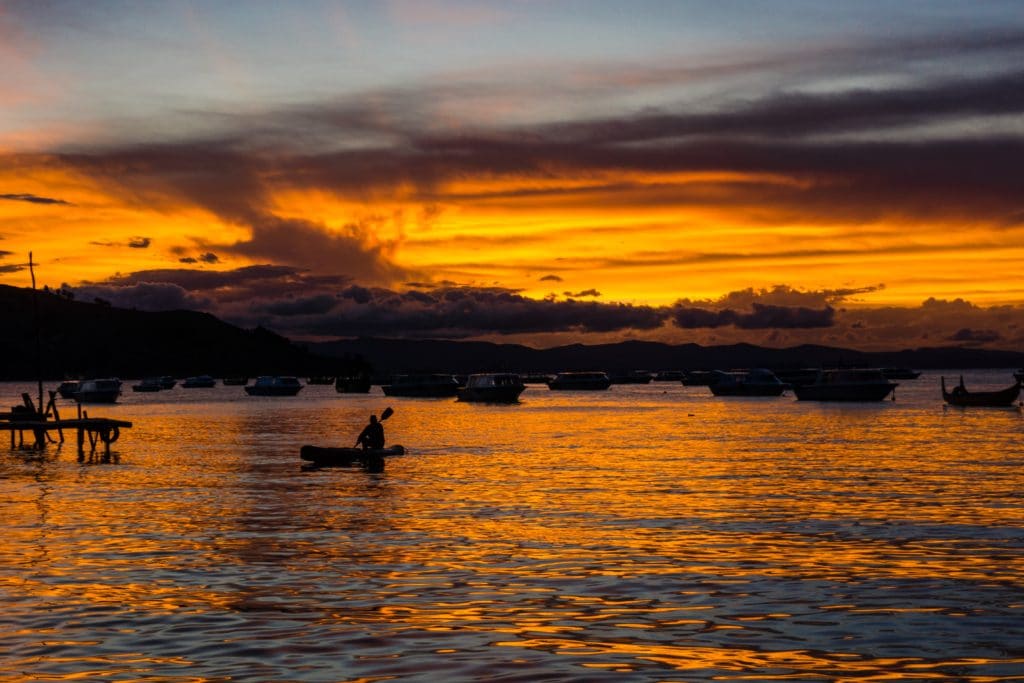 boater in lake titicaca at dusk