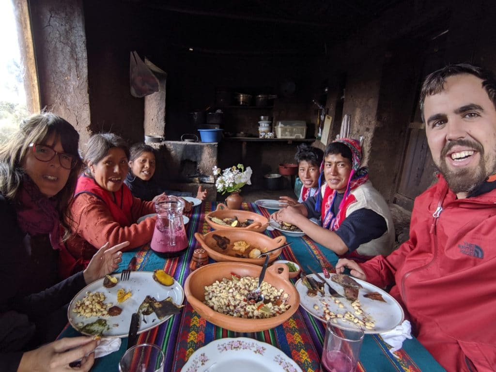 peruvian family having a meal together around a table