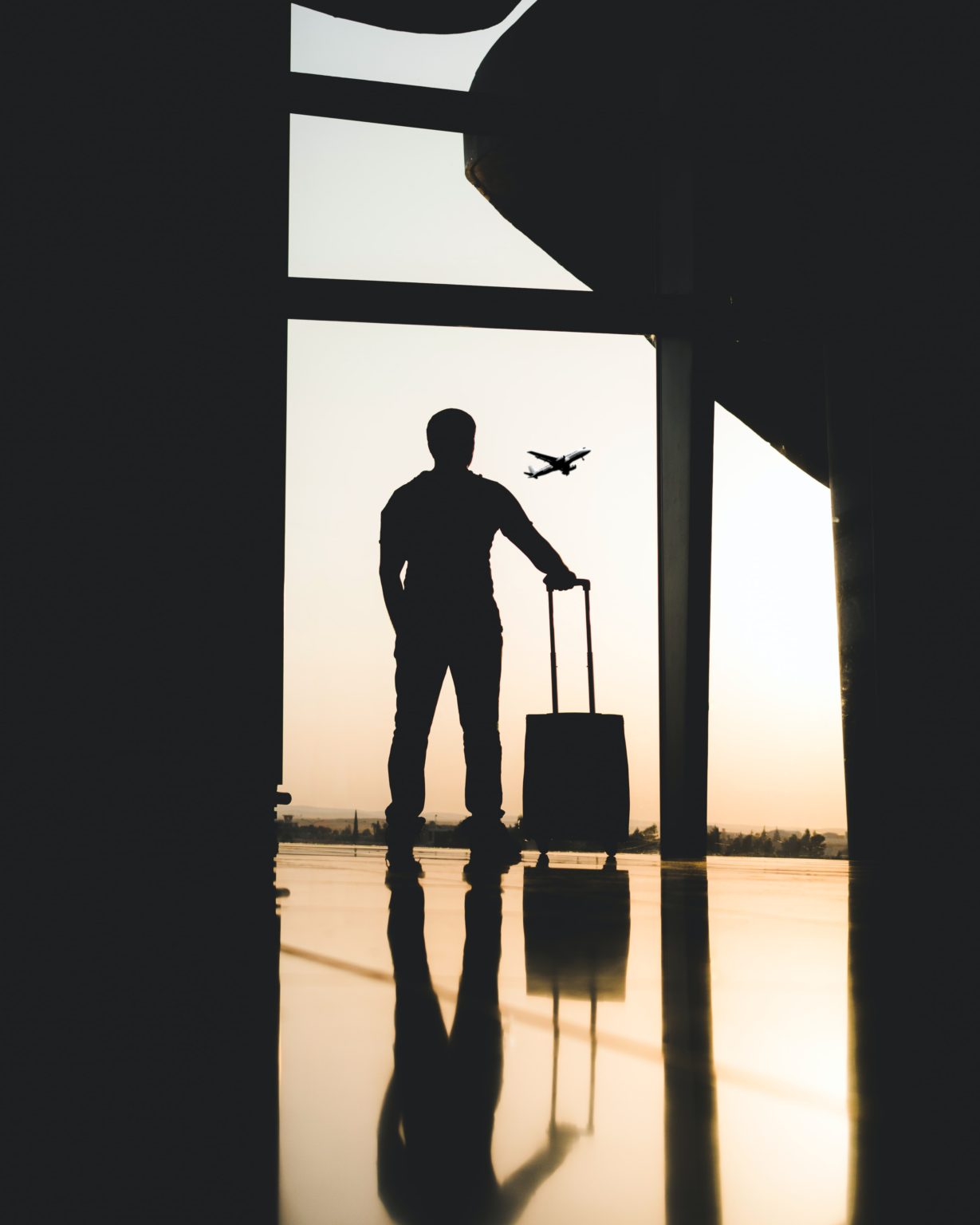 man in airport looking at flight