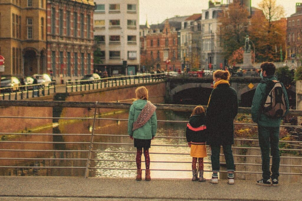 Family standing on bridge in Ghent, Belgium - travel planning
