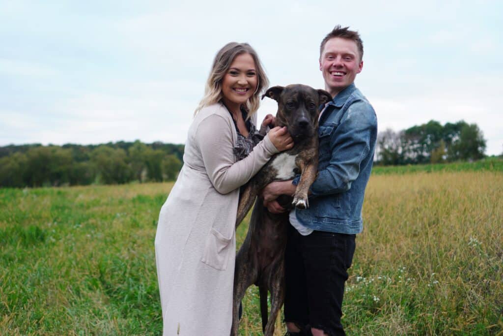 Couple holding a dog - animal welfare