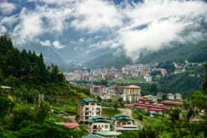 bhutan house and mountains - eco-friendly travel destinations - baboo