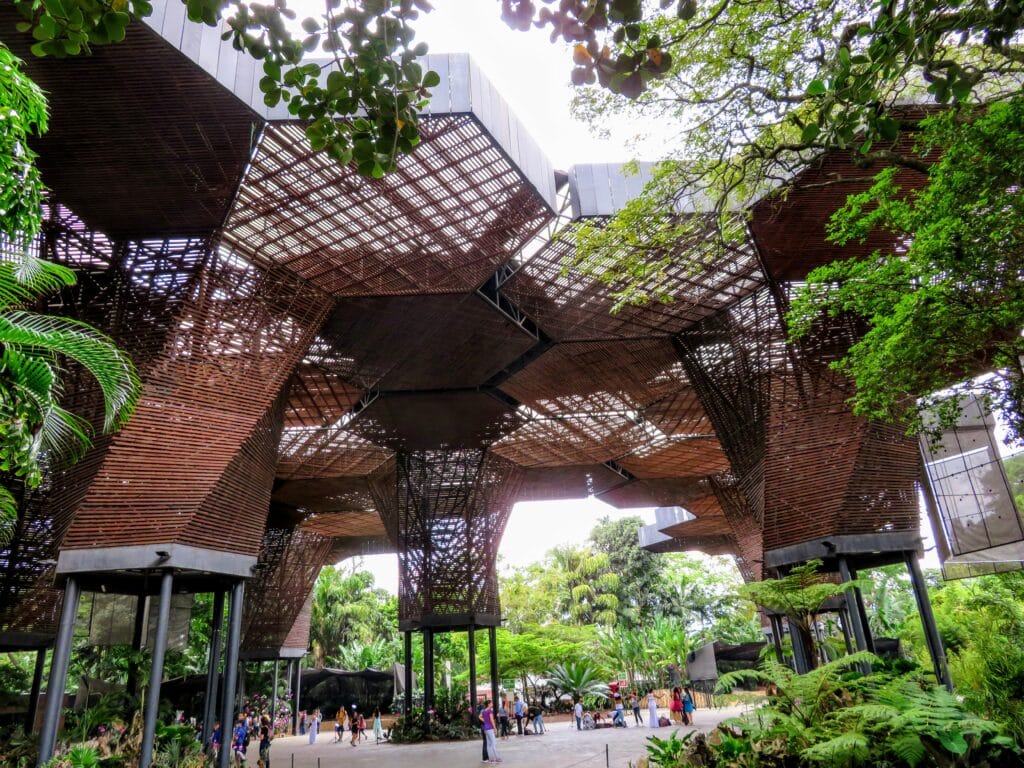 Designed by Plan B Architects in Medellin, the Orquideorama structure resembles a bouquet of giant wooden flowers that stretch more than fifty feet into the air forming a large canopy for patrons to enjoy. - baboo travel