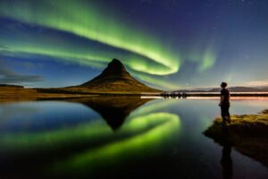 man looking at northern lights