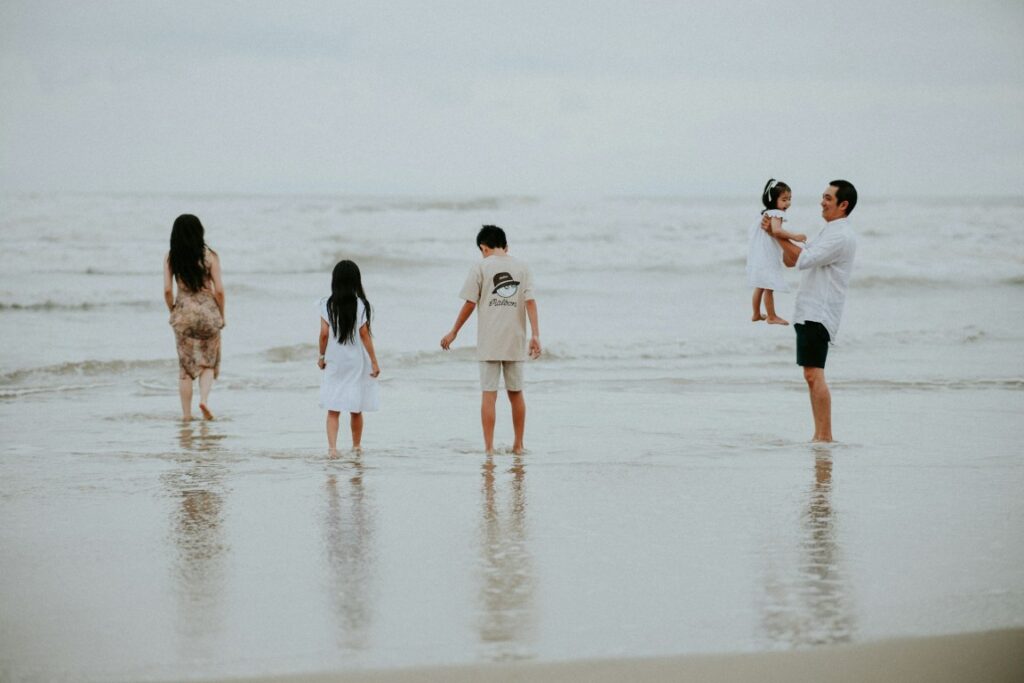family hanging out by the beach