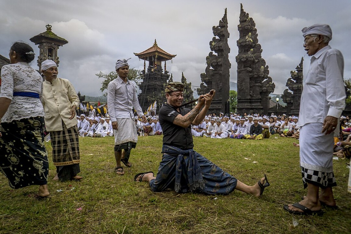 people watching a man doing a gesture on nyepi